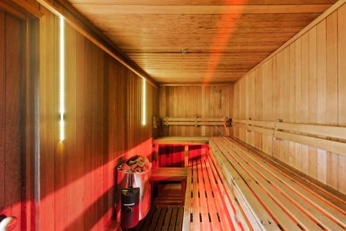 a empty empty sauna with a trash can in it at A Strand of Paradise, Oceanside Views & Pool in Mount Maunganui