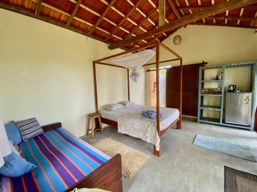 a bedroom with a bed and a mirror at Hello Homestay in Galle