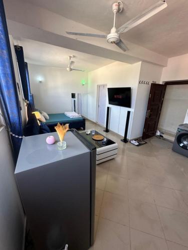 a living room with a couch and a table in a room at Rent Studio Mombassa Mtwapa Kenya No1 2people in Mtwapa