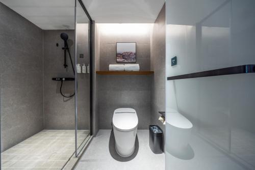a bathroom with a toilet and a glass shower at Atour Hotel Canton Tower Pearl River Binjiang Road East Guangzhou - Free Shuttle Bus Service Between Fair And Hotel During The Canton Fair in Guangzhou