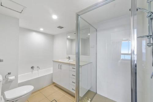 a bathroom with a shower and a toilet and a sink at Breathtaking Ocean View 2 BDR Apartment by the Beach in Gold Coast