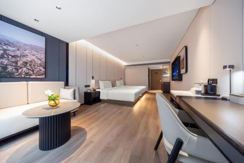 a hotel room with a bed and a table at Atour Hotel Canton Tower Pearl River Binjiang Road East Guangzhou - Free Shuttle Bus Service Between Fair And Hotel During The Canton Fair in Guangzhou