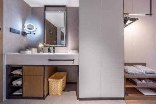 a bathroom with a sink and a mirror at Atour Hotel Canton Tower Pearl River Binjiang Road East Guangzhou - Free Shuttle Bus Service Between Fair And Hotel During The Canton Fair in Guangzhou