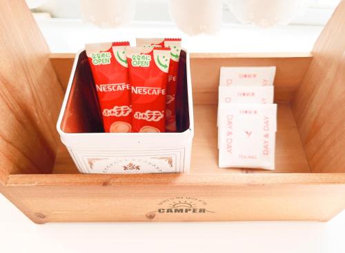 a wooden drawer with a box of chinese snacks at かぐら庵 in Kitakata