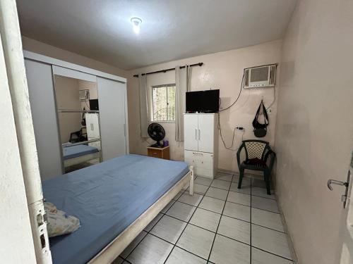 a small room with a bed and a refrigerator at Casa de Alto Padrão com Area de Lazer e Piscina - Cop 30 in Belém