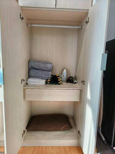 a wooden cabinet with some towels in it at Grand Horizon Imperium Residence Kuantan Studio City view in Kuantan