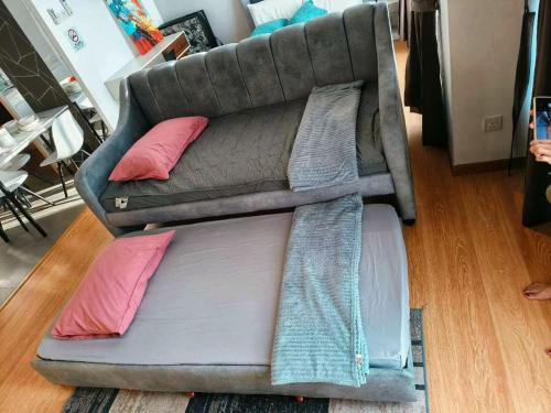 a couch with pillows on the floor in a living room at Grand Horizon Imperium Residence Kuantan Studio City view in Kuantan