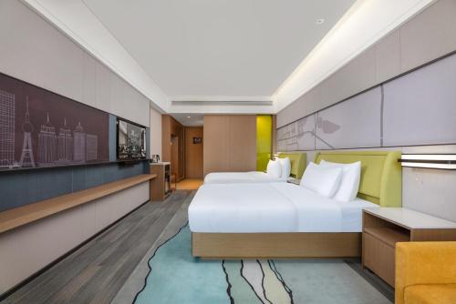 a hotel room with a bed and a couch at Meilun Hotel in Xining Haihu New Area in Xining