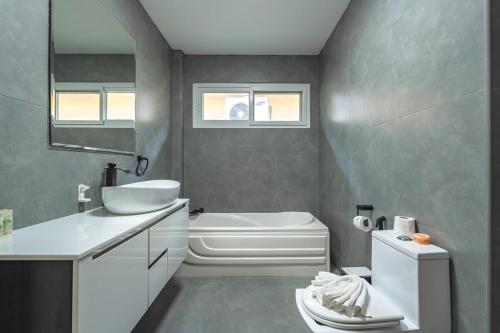 a bathroom with a sink and a tub and a toilet at V174 Great Base 2 Explore Phuket Everting you Need in Phuket Town