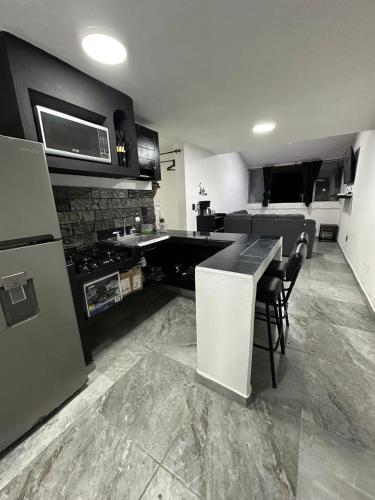 a kitchen with a stove and a counter top at departamento familiar centrico cerca de playa y plazas comerciales con wifi 200 in Puerto Vallarta