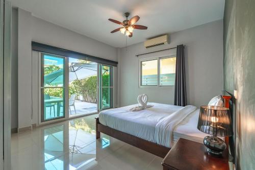 a bedroom with a bed and a ceiling fan at V174 Great Base 2 Explore Phuket Everting you Need in Phuket Town