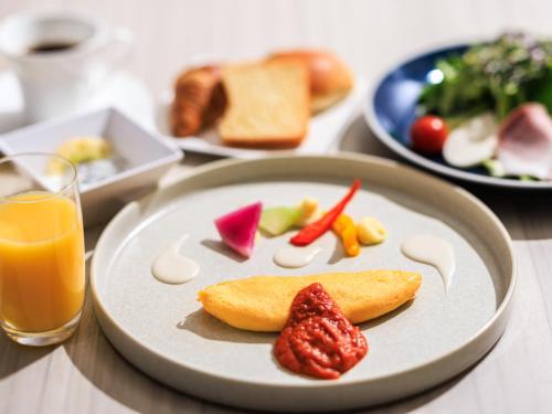 a plate of food with fruit on a table at Kamakura Prince Hotel in Kamakura