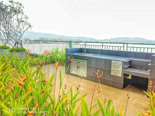 a bench in a garden with a view of the water at Grand Horizon Imperium Residence Kuantan Studio City view in Kuantan