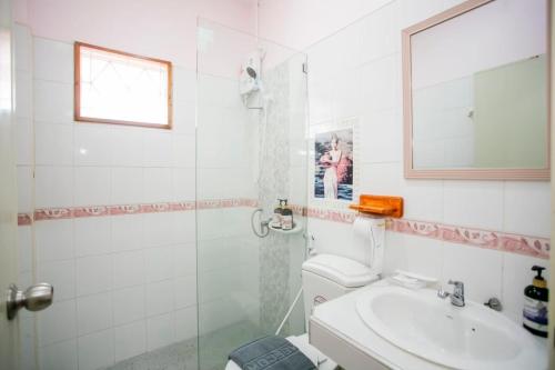 a bathroom with a shower and a toilet and a sink at Ratana Boutique Resort - Mae Phim in Ban Ang