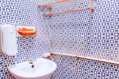 a bathroom with a sink and a toilet in it at Urbanview at Wedika Hotel Bengkulu in Bengkulu