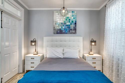 a bedroom with a bed with two night stands and two lamps at 20 Hypolita Street in St. Augustine