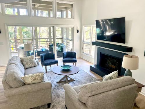 a living room with two couches and a tv at 2975 Deer Point Dr in Johns Island