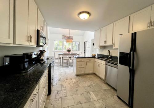 a kitchen with white cabinets and a table in it at 2975 Deer Point Dr in Johns Island