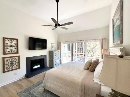 a bedroom with a bed and a fireplace at 2975 Deer Point Dr in Johns Island
