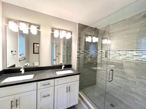 a bathroom with two sinks and a glass shower at 2975 Deer Point Dr in Johns Island