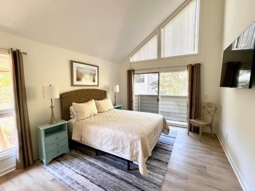 a bedroom with a bed and two windows at 2975 Deer Point Dr in Johns Island