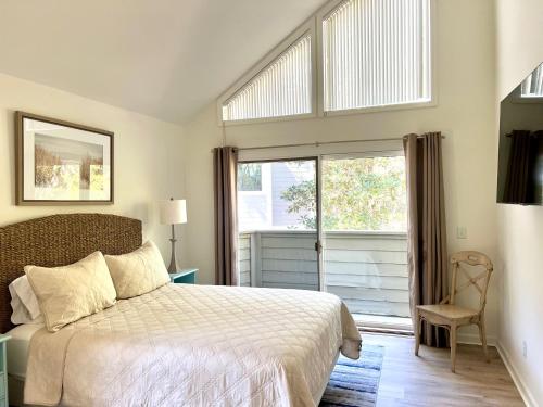 a bedroom with a bed and a large window at 2975 Deer Point Dr in Johns Island