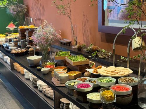 a buffet line with appetizers and other food items at Hotel Il Palazzo in Fukuoka