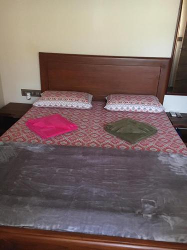 a bedroom with a bed with two pillows on it at Coastal Stay with private Beach Access KAPU in Udiyāvara