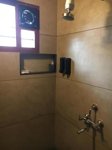 a bathroom with a sink and a clock on the wall at Coastal Stay with private Beach Access KAPU in Udiyāvara