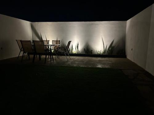 a group of chairs and a table against a wall at New Modern Acapulco Diamante House Getaway with Pool View and Beach Club in Acapulco
