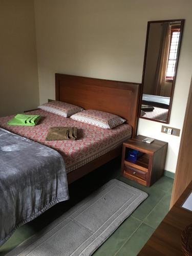 a bedroom with two beds and a mirror at Coastal Stay with private Beach Access KAPU in Udiyāvara