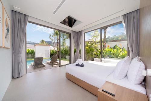 Postel nebo postele na pokoji v ubytování Himmapana Villas - Grand Valley