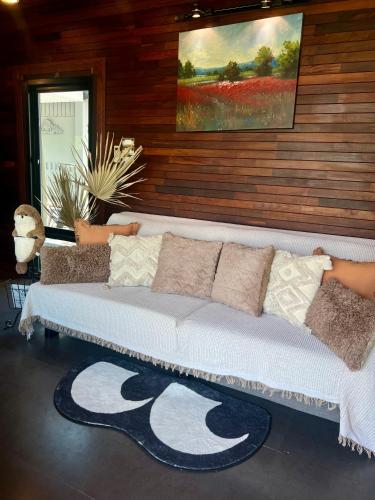 a couch with pillows on it in a room at Beach Villa KUIBURI in Ban Khok Rak