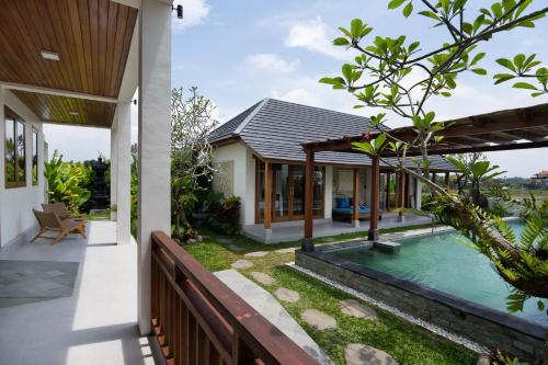 an external view of a house with a swimming pool at Oemah Manureva Ubud in Mambat