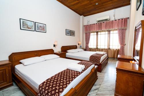 Ένα ή περισσότερα κρεβάτια σε δωμάτιο στο D Ajenk Boutique Guesthouse