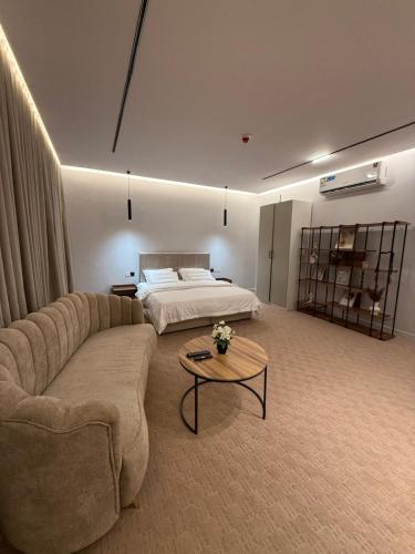 a living room with a couch and a bed at افاق المسكن in Al Madinah