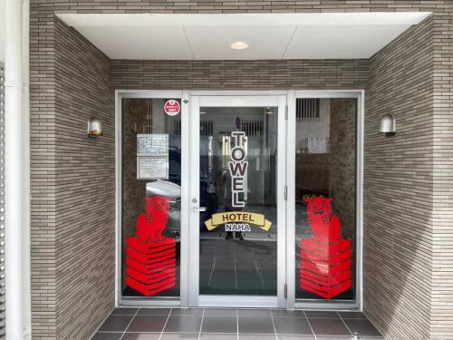 a door to a store with red sculptures in front of it at New Normal Condo in KENCHOMINAMIGUCHI ニューノーマルコンドイン県庁南口 in Naha