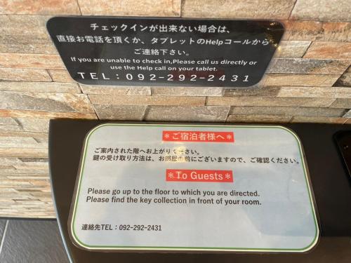 a sign that is on the side of a building at New Normal Condo in KENCHOMINAMIGUCHI ニューノーマルコンドイン県庁南口 in Naha