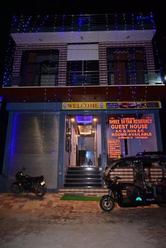 a motorcycle parked in front of a building at night at SSR-Shree Shyam Residency in Khātu