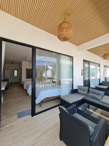 a living room with a couch and a bed at Myhoa Lagoon - Kiting Town in Phan Rang