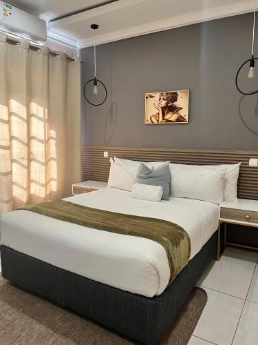 a bedroom with a large bed in a room at LIVE-INN LUXURY SUITES in Mahalapye