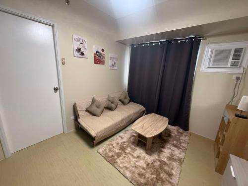 a small living room with a couch and a table at Amoore Avida Tower 2 in Cagayan de Oro