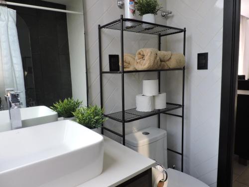 a bathroom with a white sink and a toilet at Loft urbano, Ciudad Guatemala, EON in Estación Pamplona