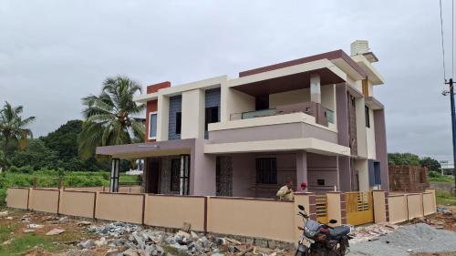 a house under construction with a motorcycle in front at Holy spirit Arul lobo Peace in Kalyānpur