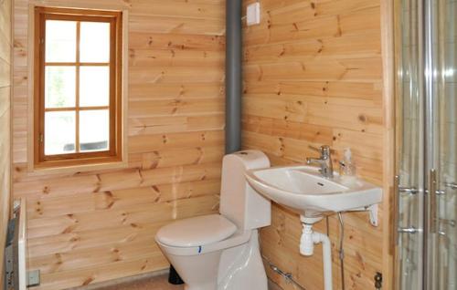 a bathroom with a toilet and a sink at Lovely home in Ringstad in Kil