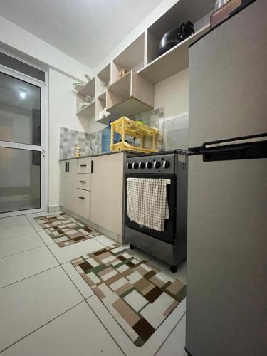 a kitchen with a stove and a refrigerator at Imali homes in Mombasa