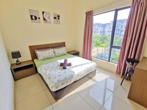 a bedroom with a bed and a large window at Nature Home - Swiss Garden Resort Residences in Kuantan