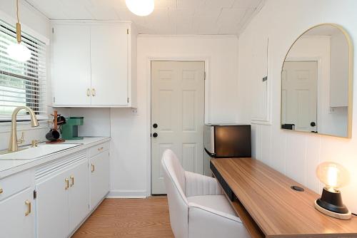 a kitchen with white cabinets and a wooden counter top at Lake Hickory Trio 2BR Green Unit in Hickory
