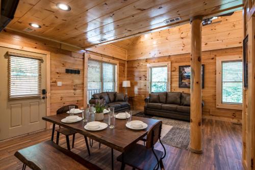 a living room with a table and a couch at The Bear Club in Pigeon Forge
