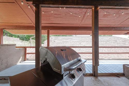 a grill sitting inside of a building with a window at Lake Hickory Trio 2BR Green Unit in Hickory